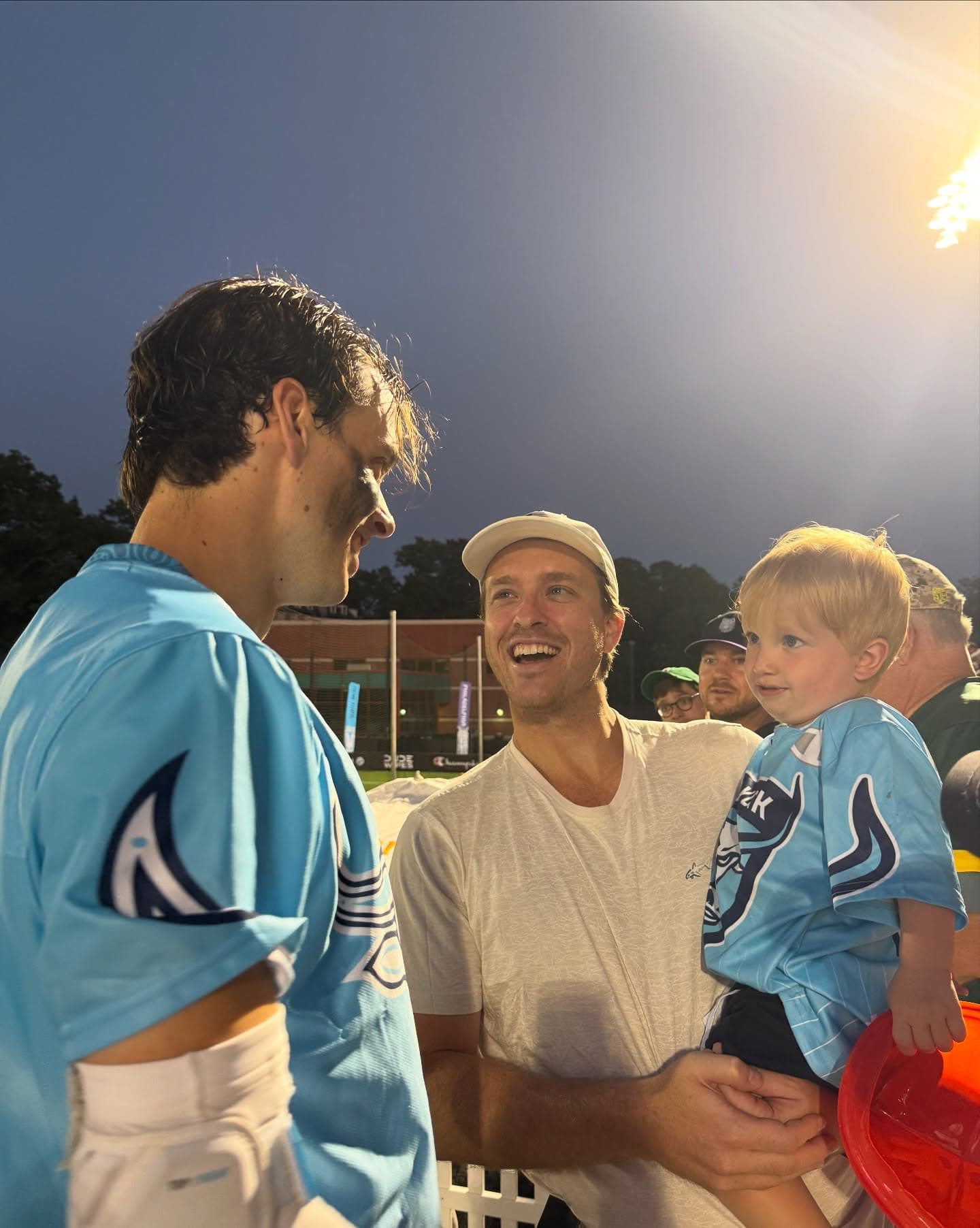 Xander Dickson speaking with a family at an event